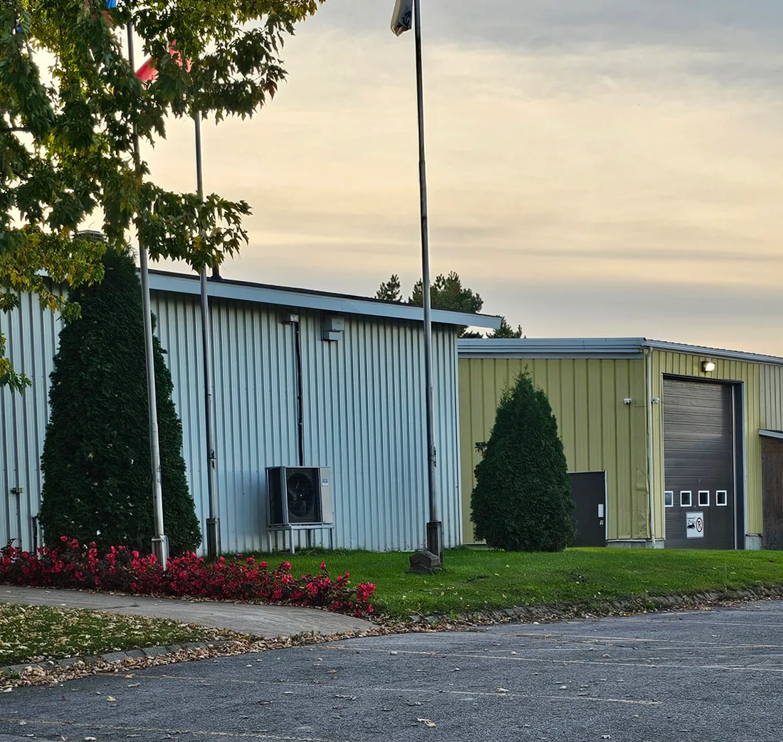 A municipal public works building at the edge of town